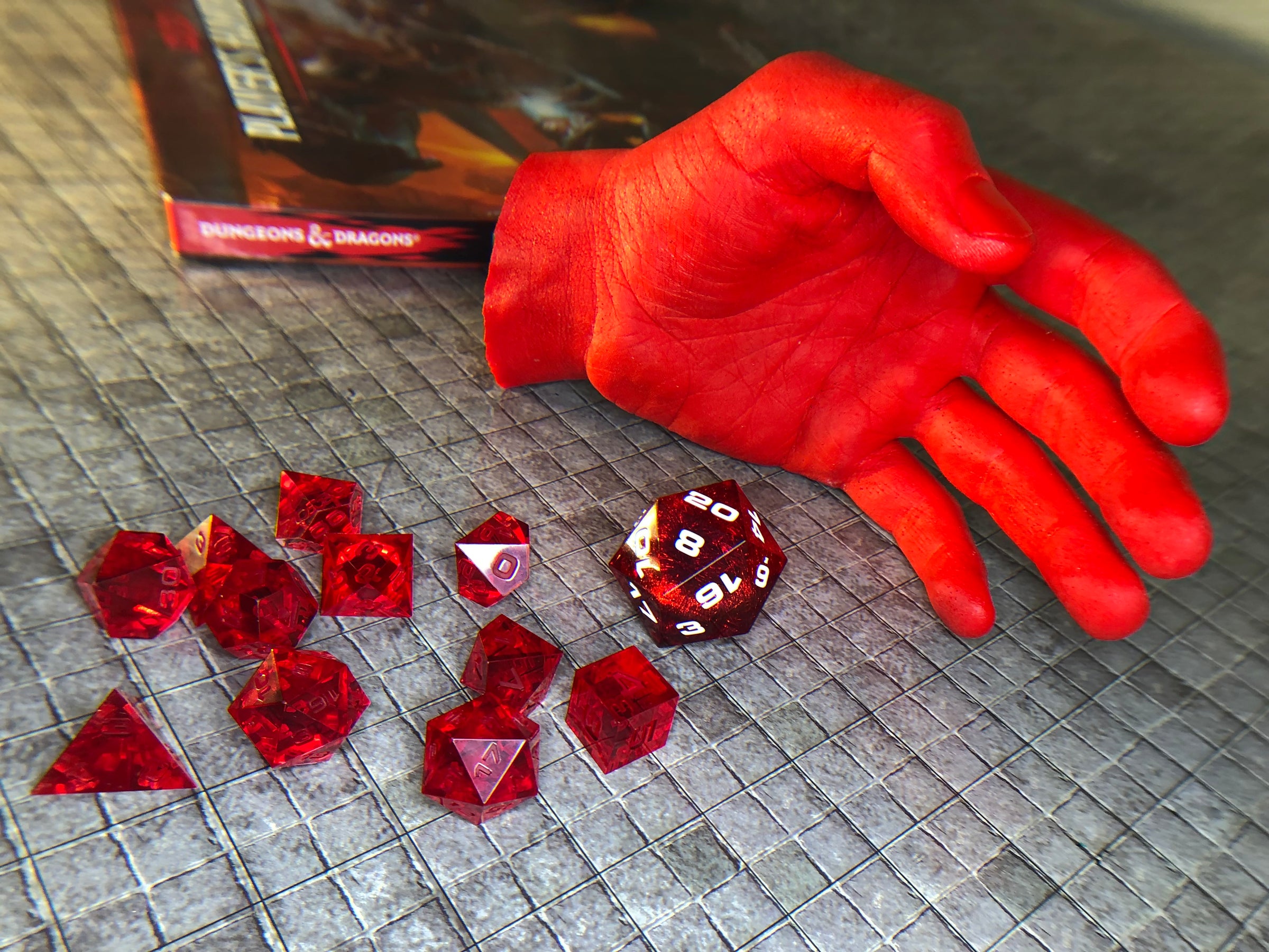 Red Aether Objects dice and red resin hand